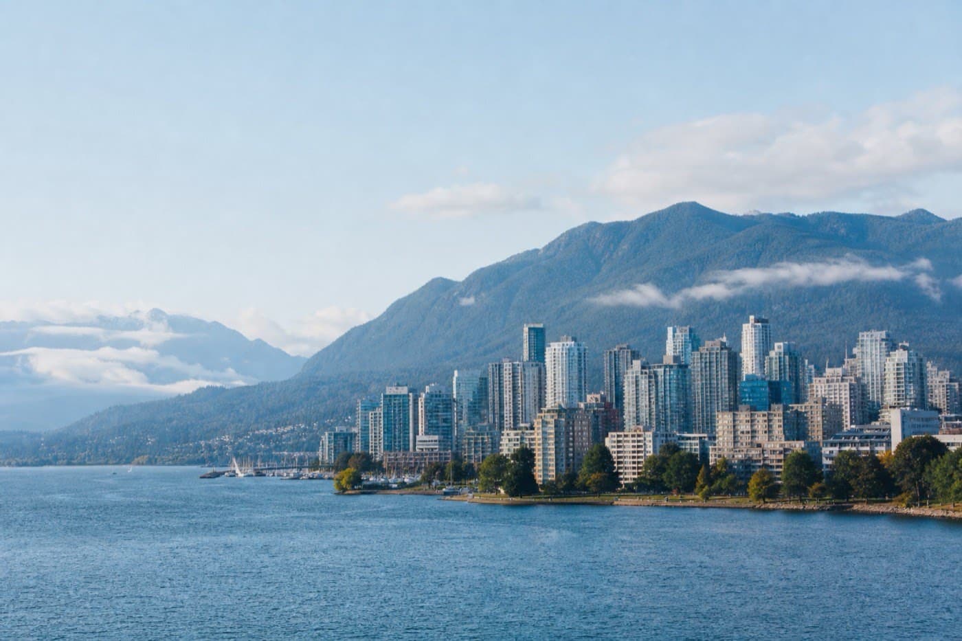 Vancouver harbor with mountains and glass towers in crisp Pacific light, Canada