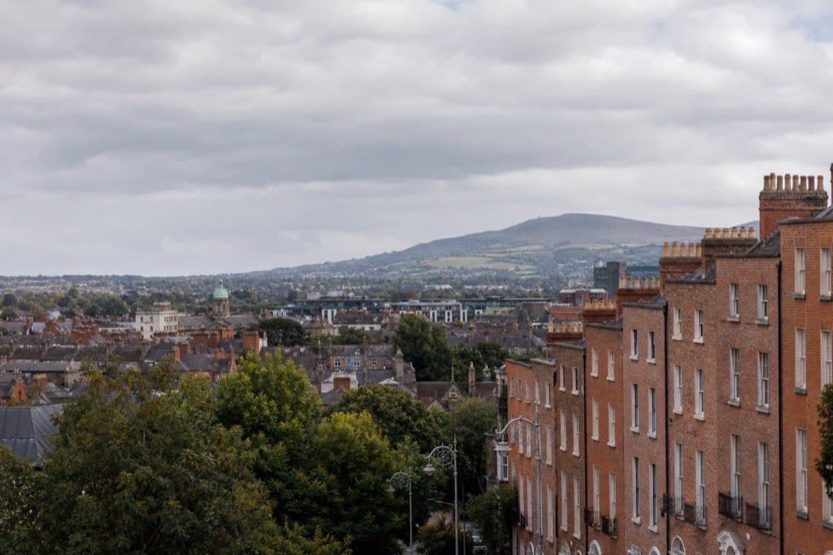 Dublin Georgian streetscape and coastal green hills under cloudy Irish light, Ireland