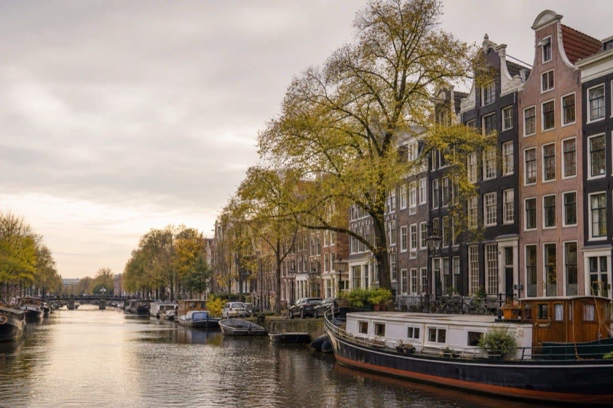 Amsterdam canal houses and waterways under soft Dutch sky, Netherlands