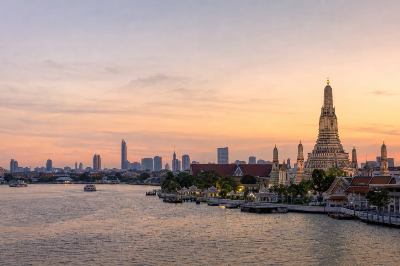 Bangkok skyline with temple spires and the Chao Phraya River at dusk, Thailand