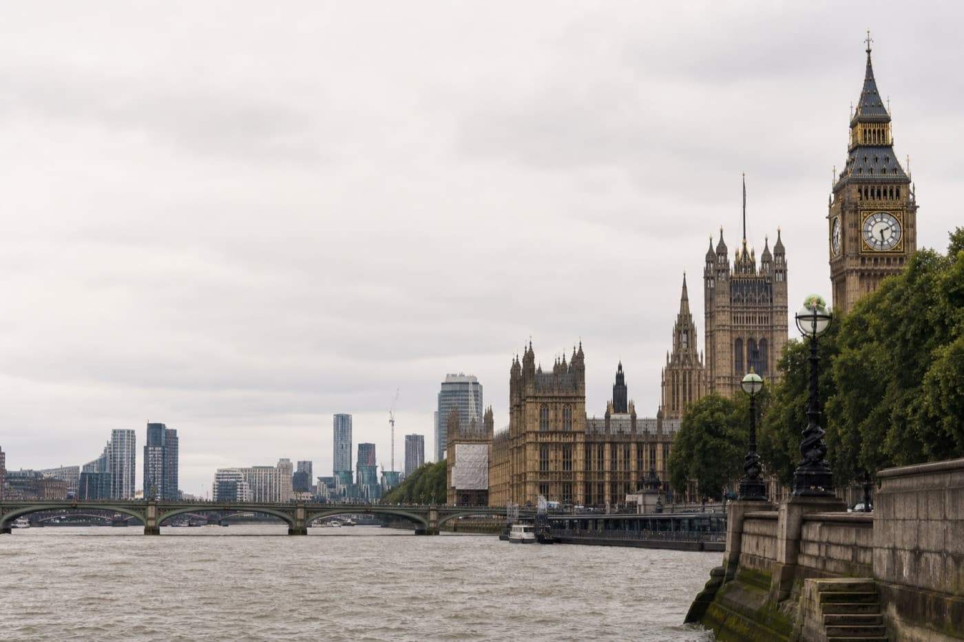 London Thames riverfront with Westminster skyline in muted editorial light, United Kingdom